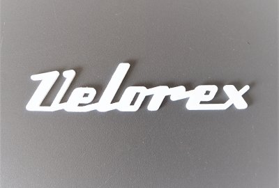 Emblemat VELOREX, plastik, biały